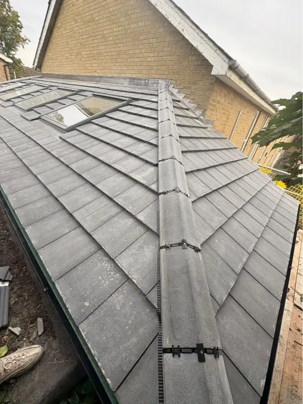 Completed grey roof tiles, hip tiles and VELUX roof window at King’s Church Mildenhall